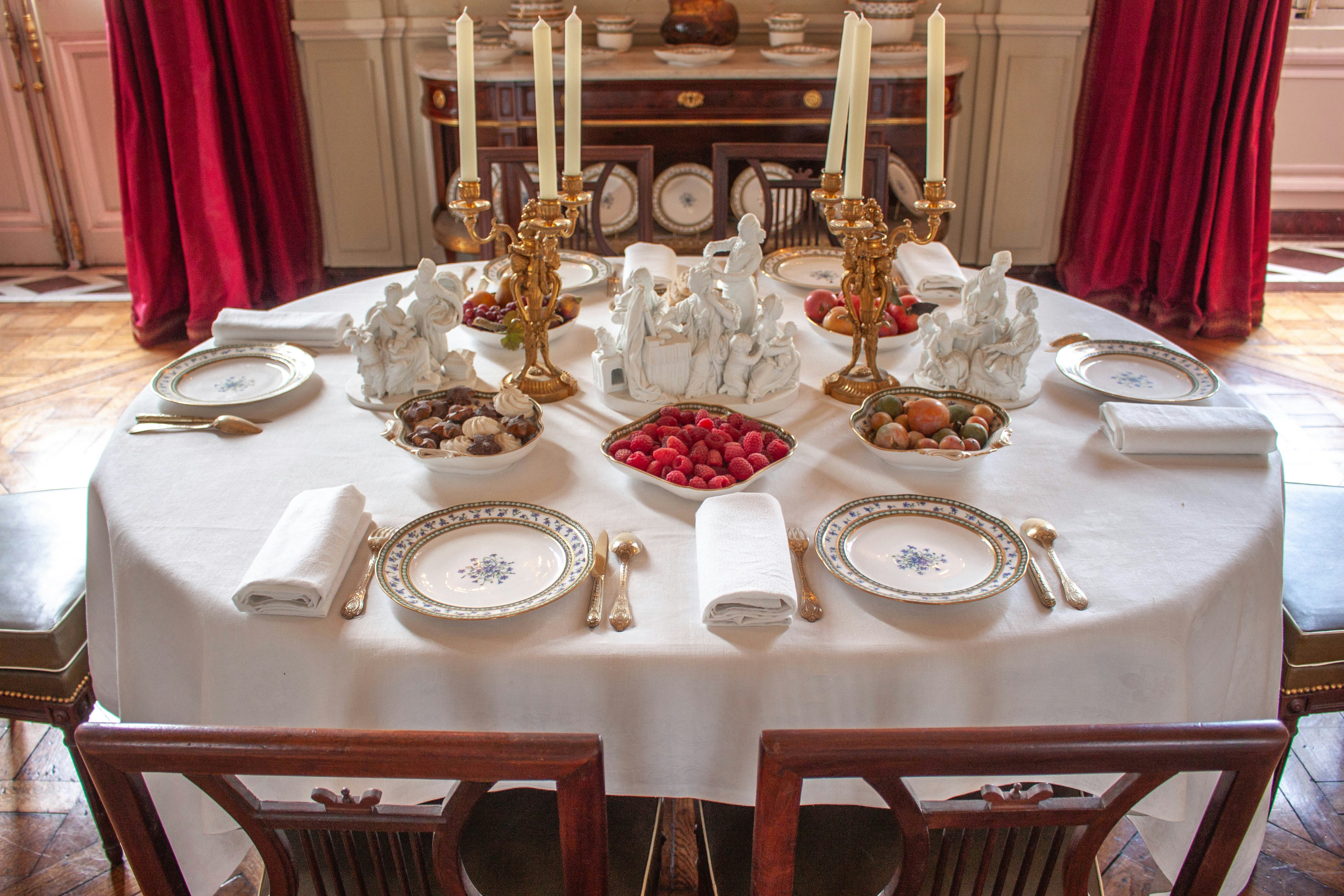 An elegantly set table with a glass of Eagle Rare and food pairings