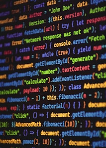 Programming code is shown in a colorful display.