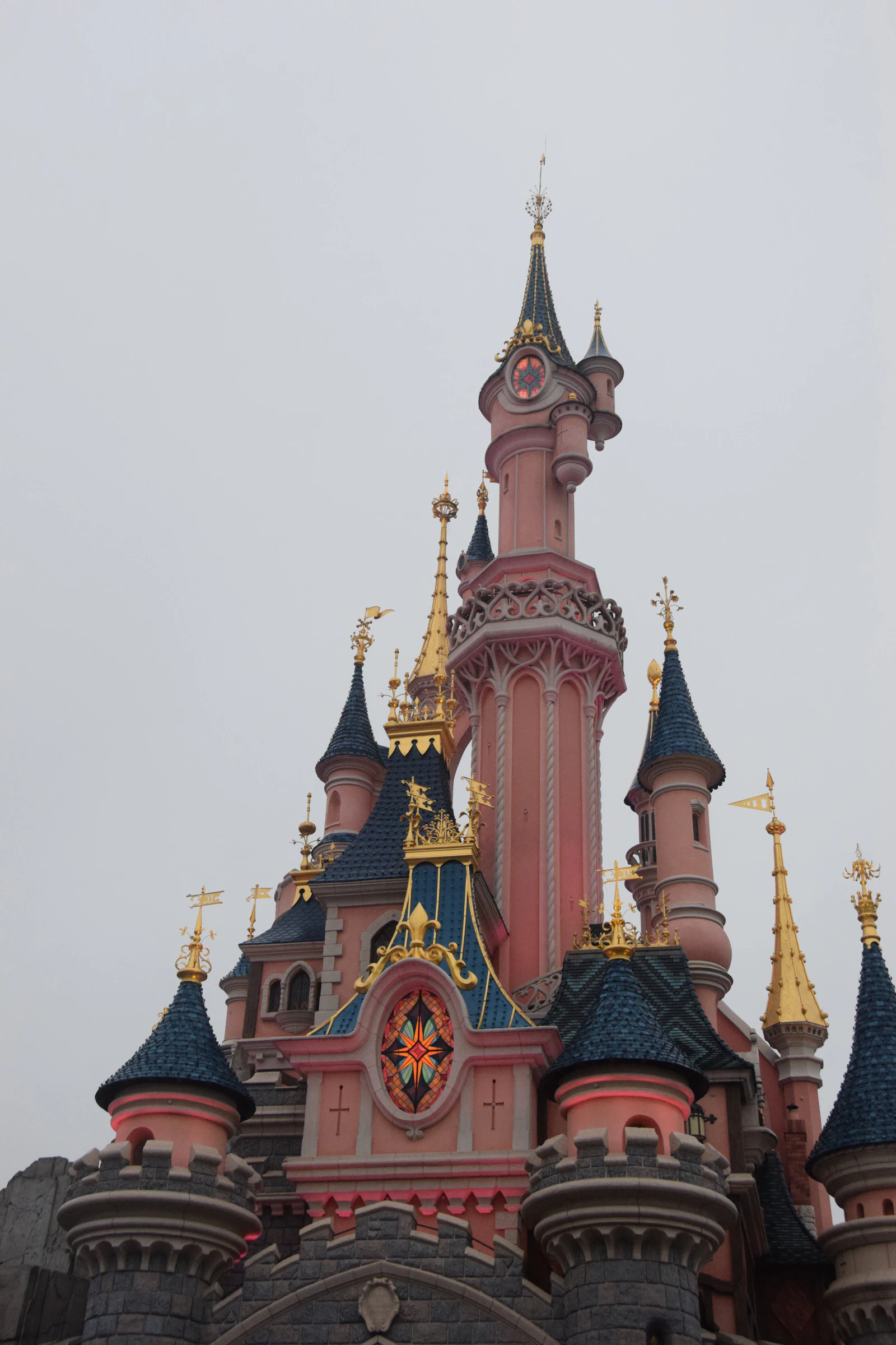 Sleeping Beauty Castle lit at night at Disneyland Paris