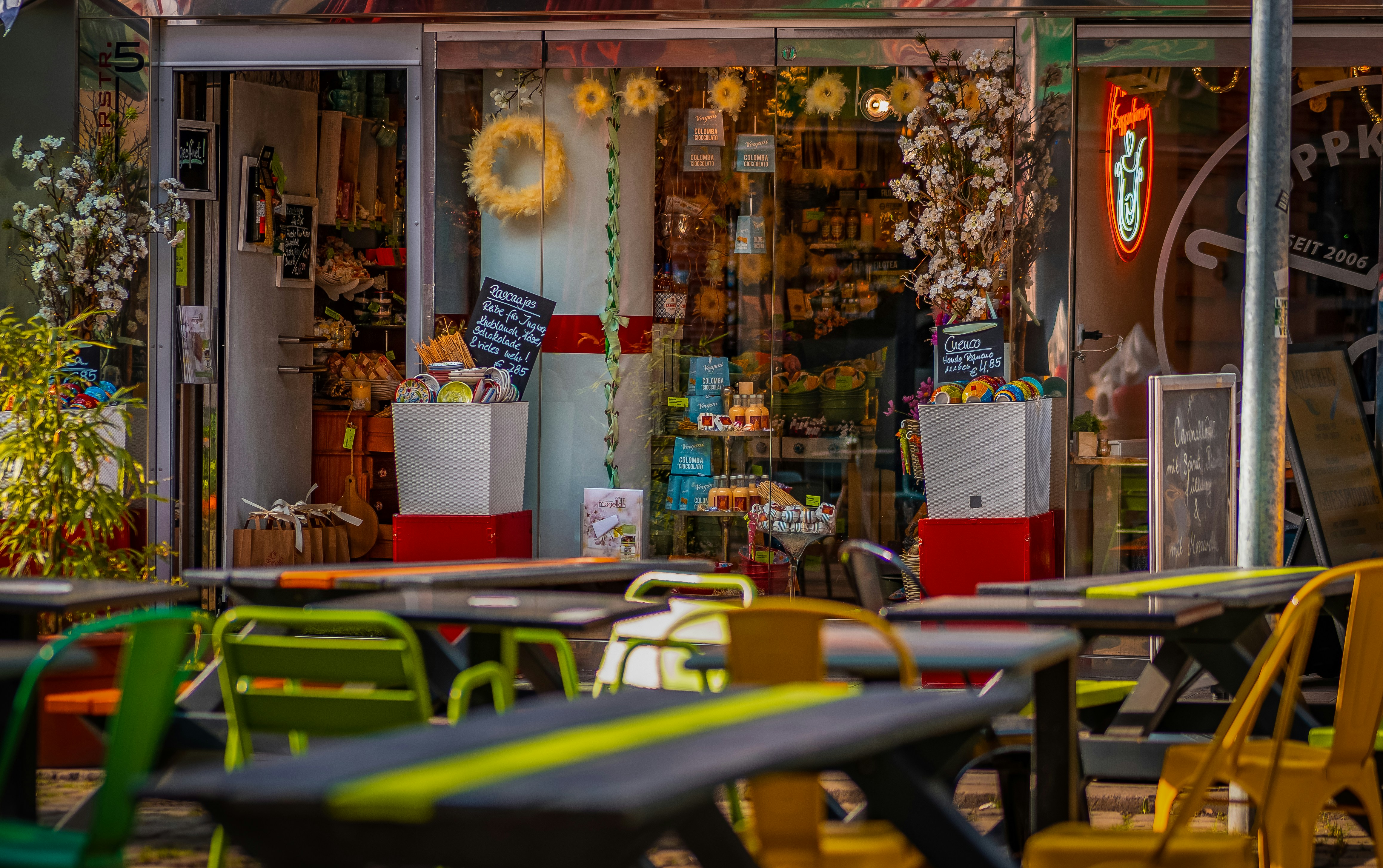 Cafe exterior with tables and chairs ready for customers.