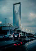 Cars drive near the kingdom tower in riyadh.