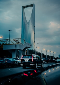 Cars drive near the kingdom tower in riyadh.