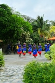 People dance in bright clothing.