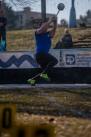 A hammer thrower spins and throws the hammer.