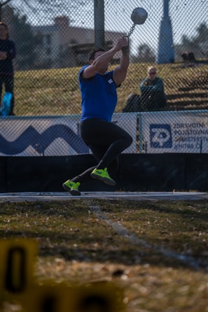 A hammer thrower spins and throws the hammer.