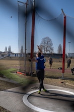 Athlete throws a shot put during practice.