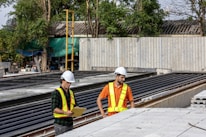 Construction workers review plans at a job site.
