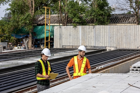 Construction workers review plans at a job site.