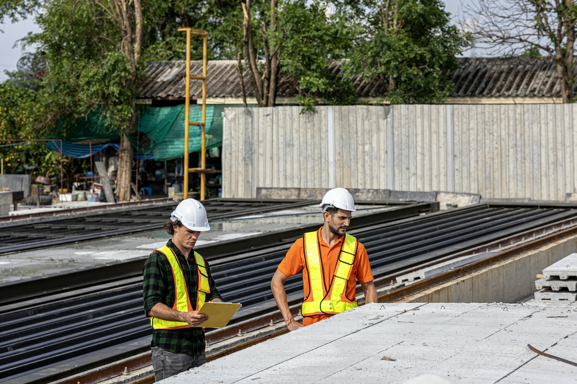 Construction workers review plans at a job site.