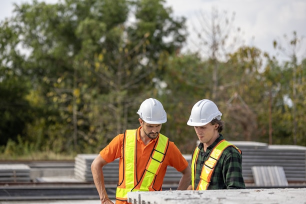 Construction workers are inspecting plans on the jobsite.