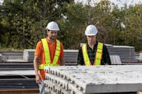 Construction workers inspect concrete slabs.