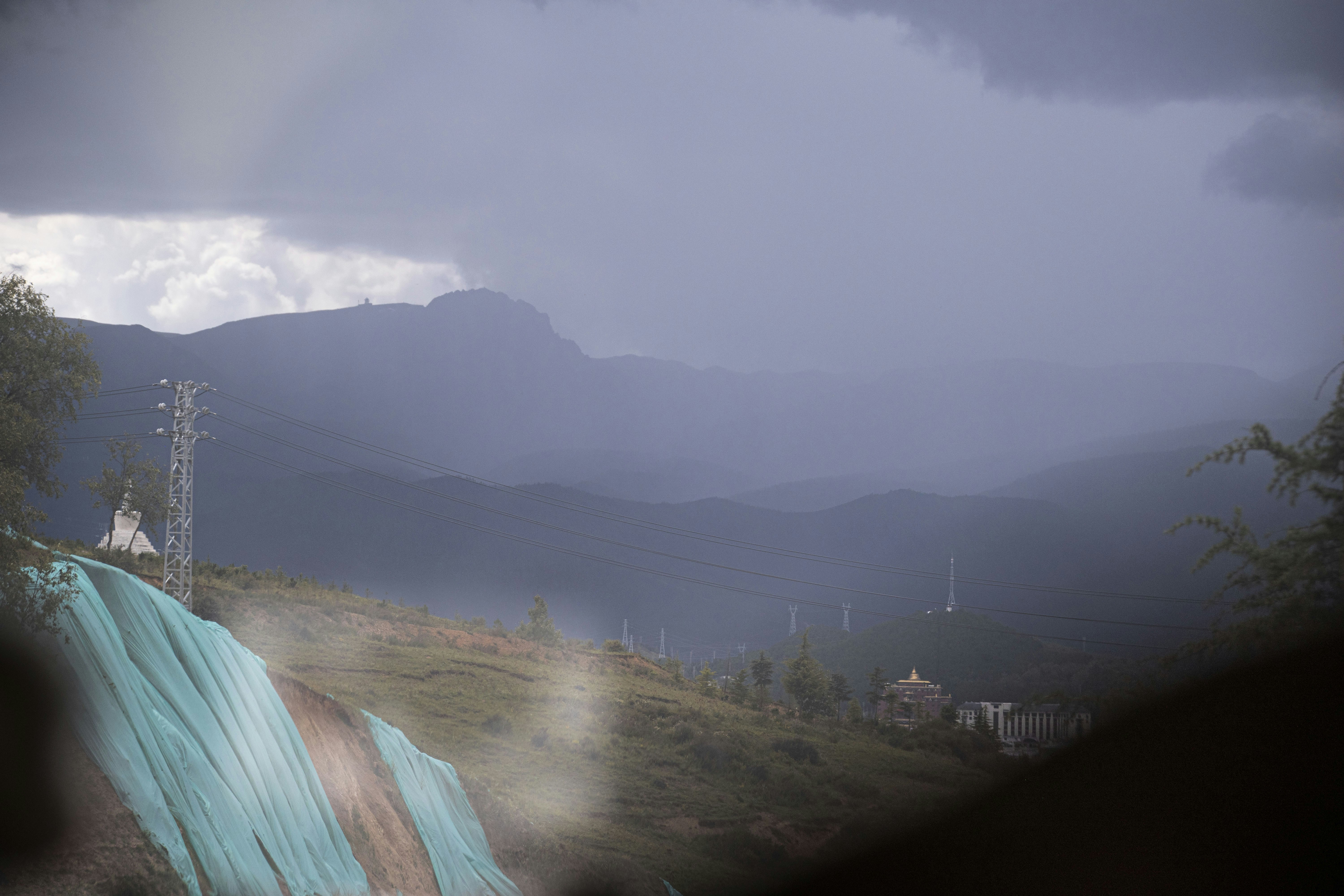 Mountains shrouded in a misty, stormy day.