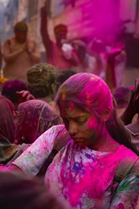 People covered in colorful powder celebrate holi.