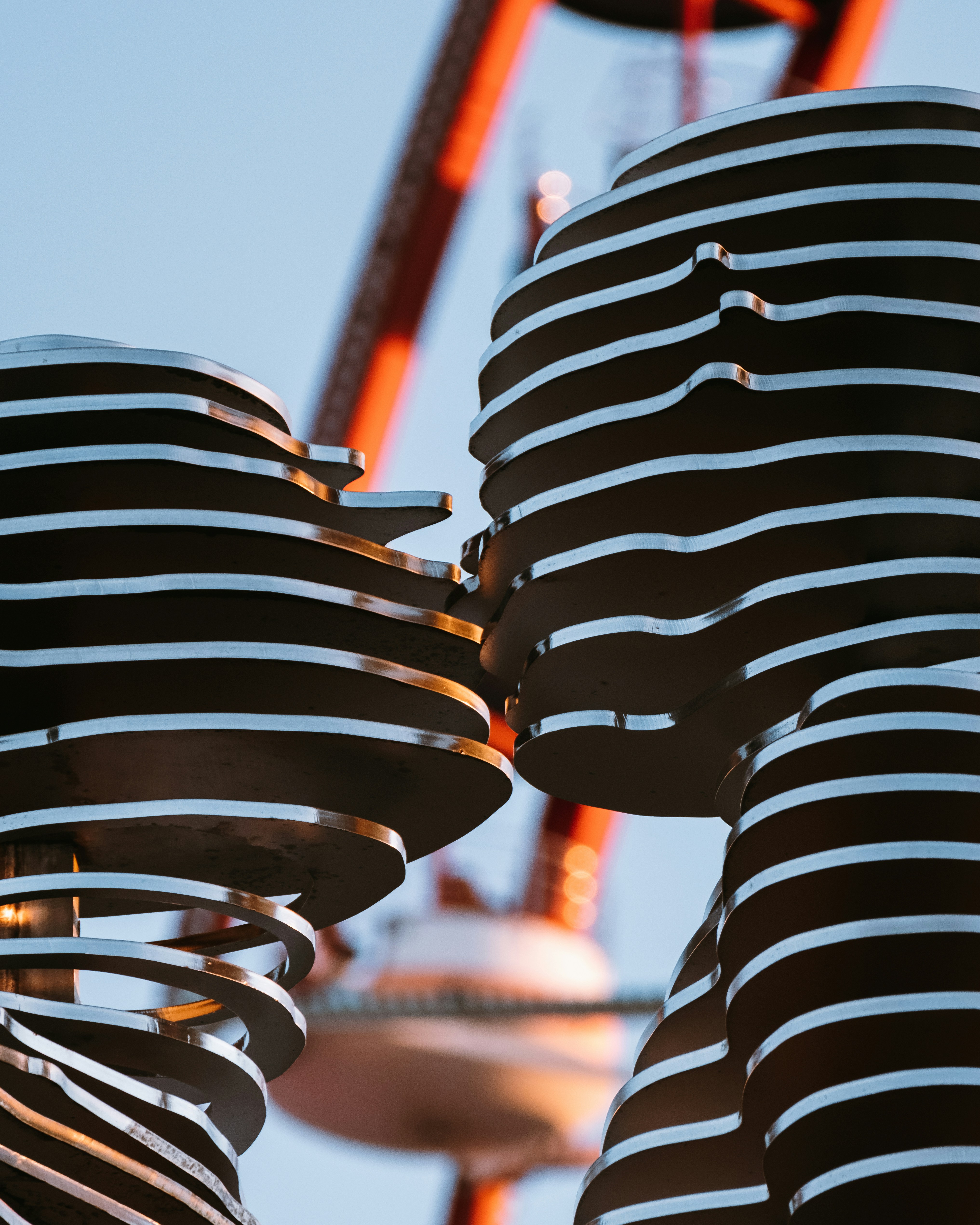 Layered metal sculpture of kissing figures.