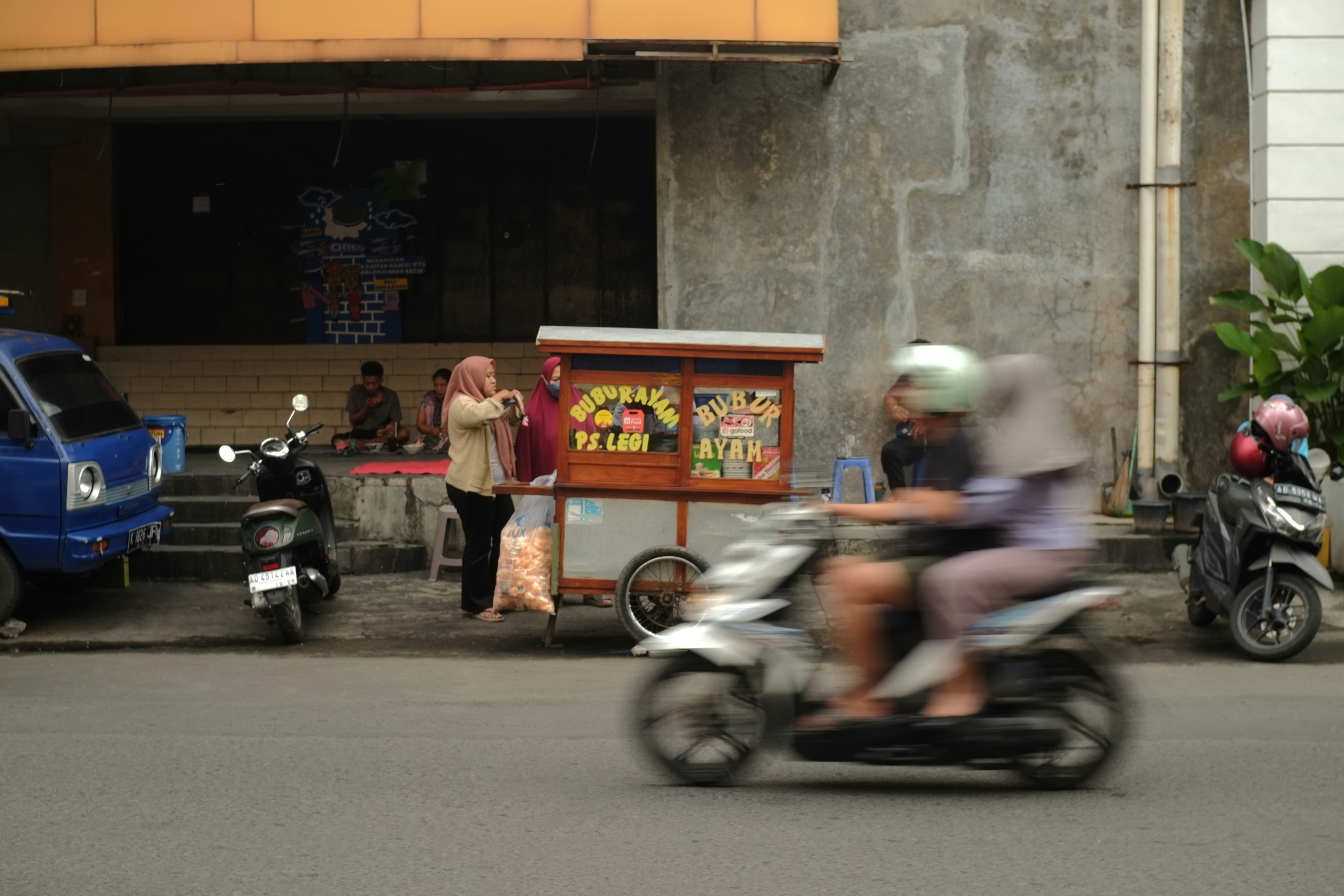 Street scene with food cart and people