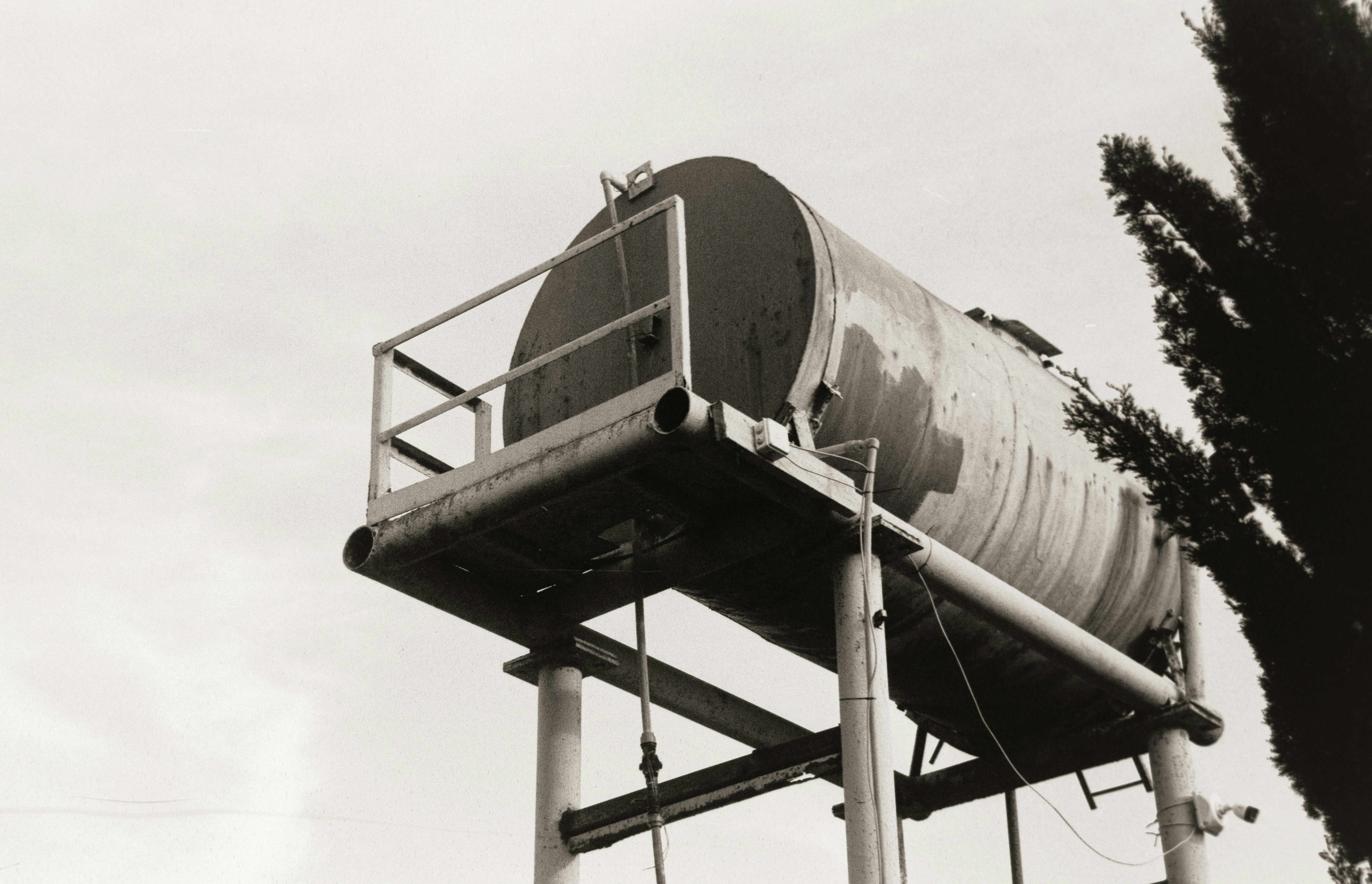 A water tank sits atop a tall metal structure.