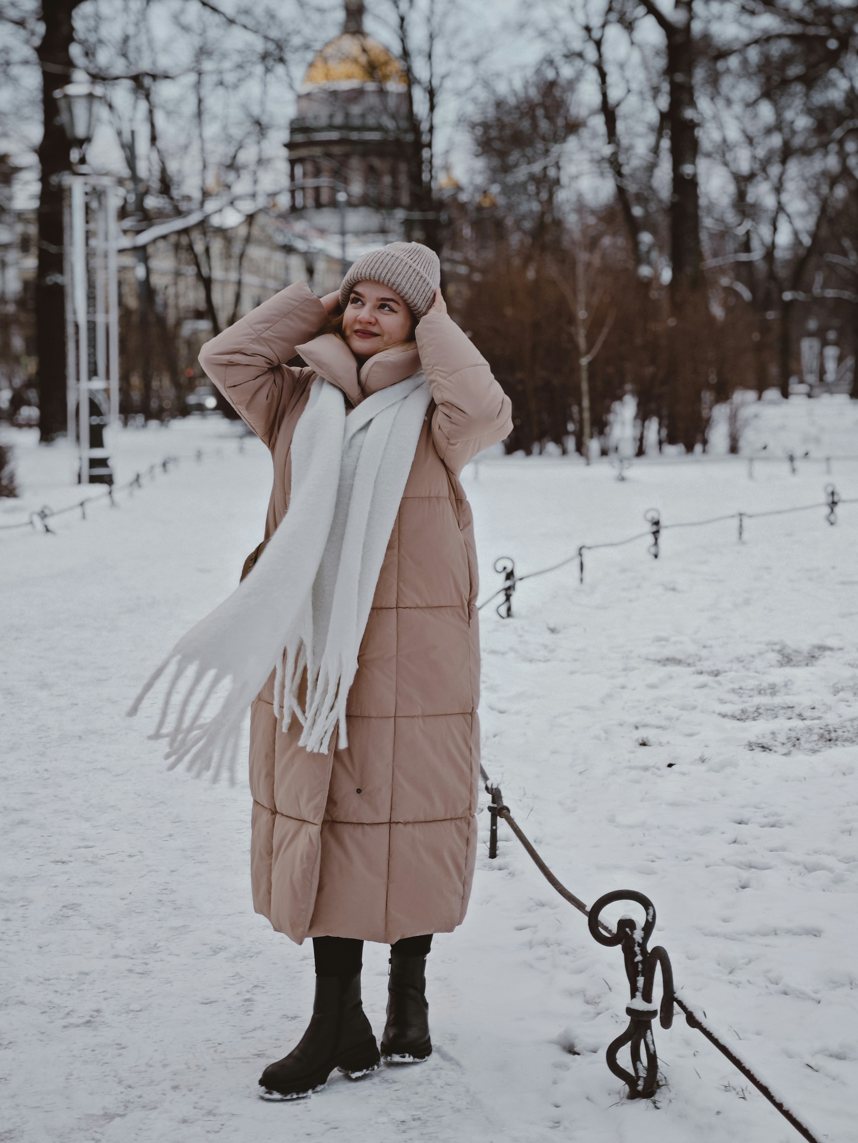 Woman enjoys a snowy day outdoors.