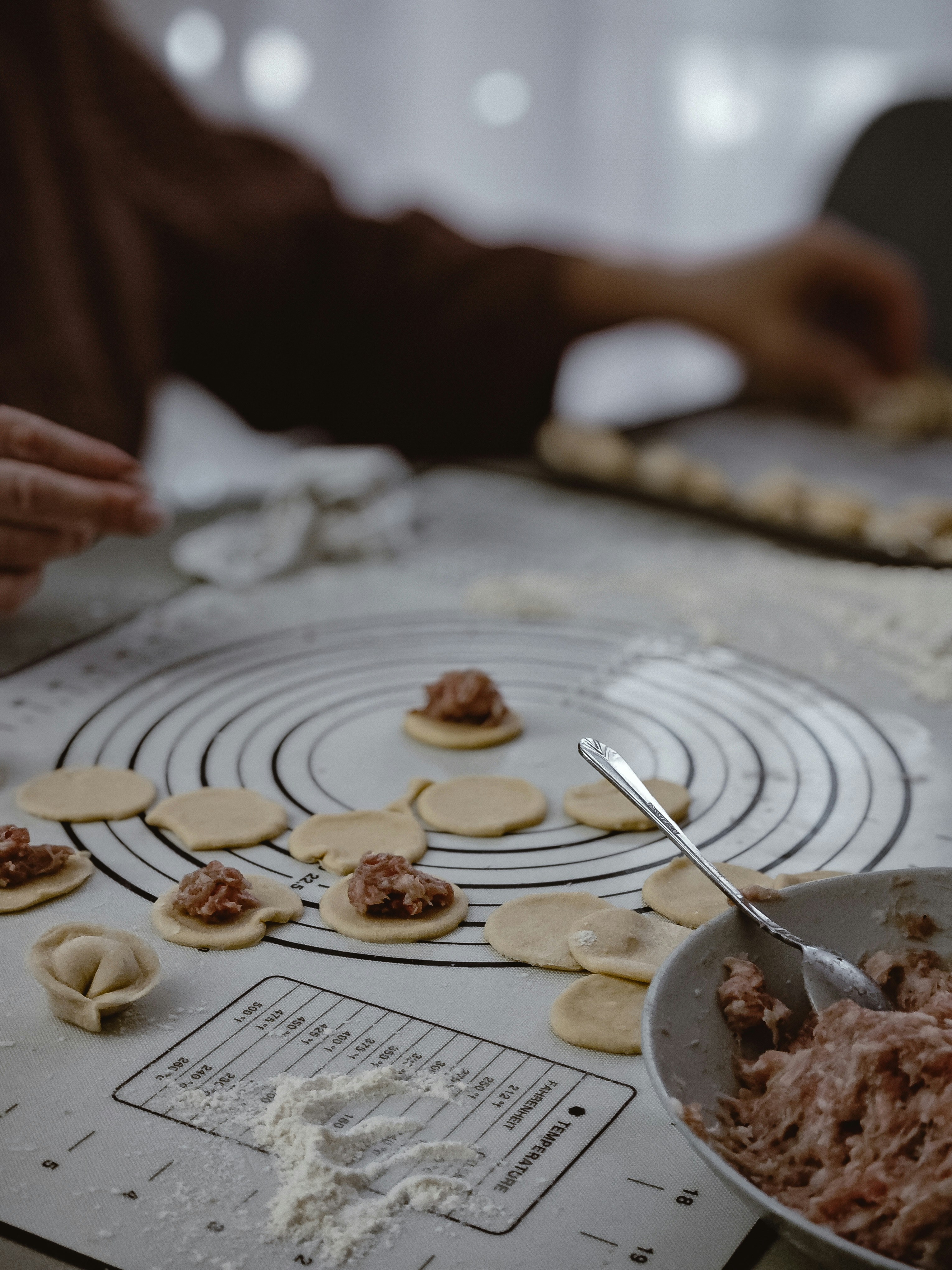 Making dumplings on a kitchen counter.