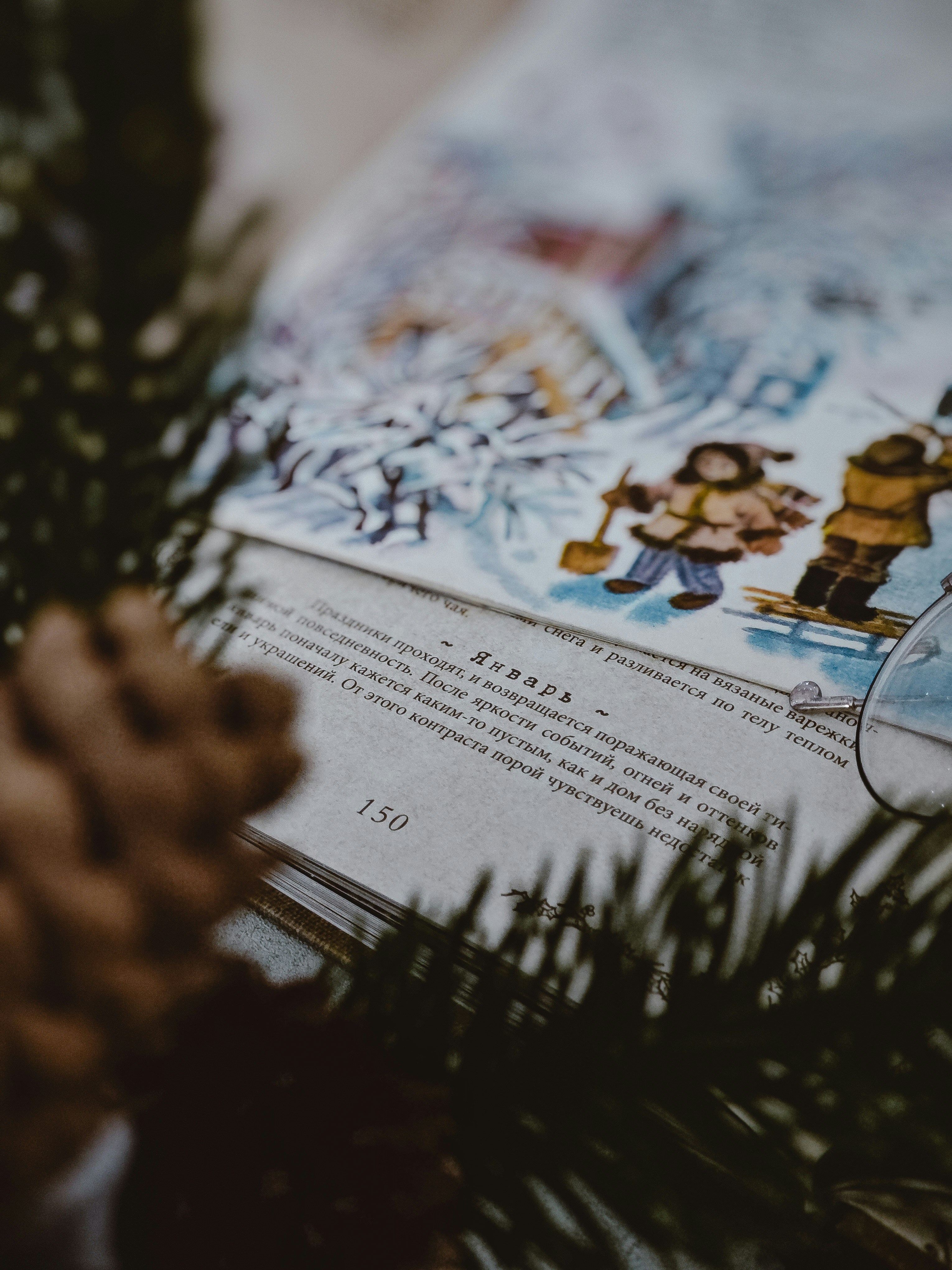 An open book shows a winter scene illustration.