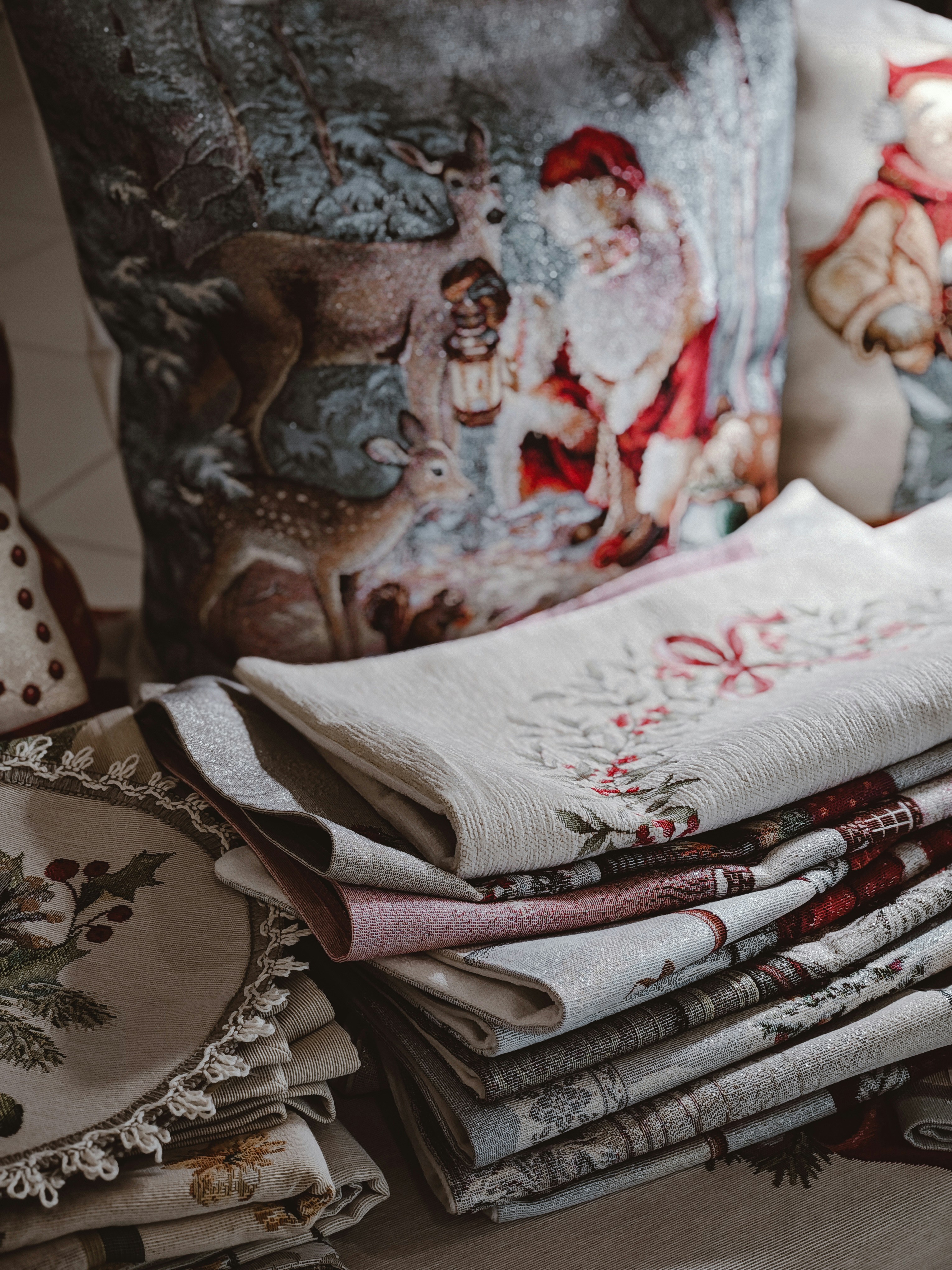Christmas-themed pillows and folded napkins arranged nicely.