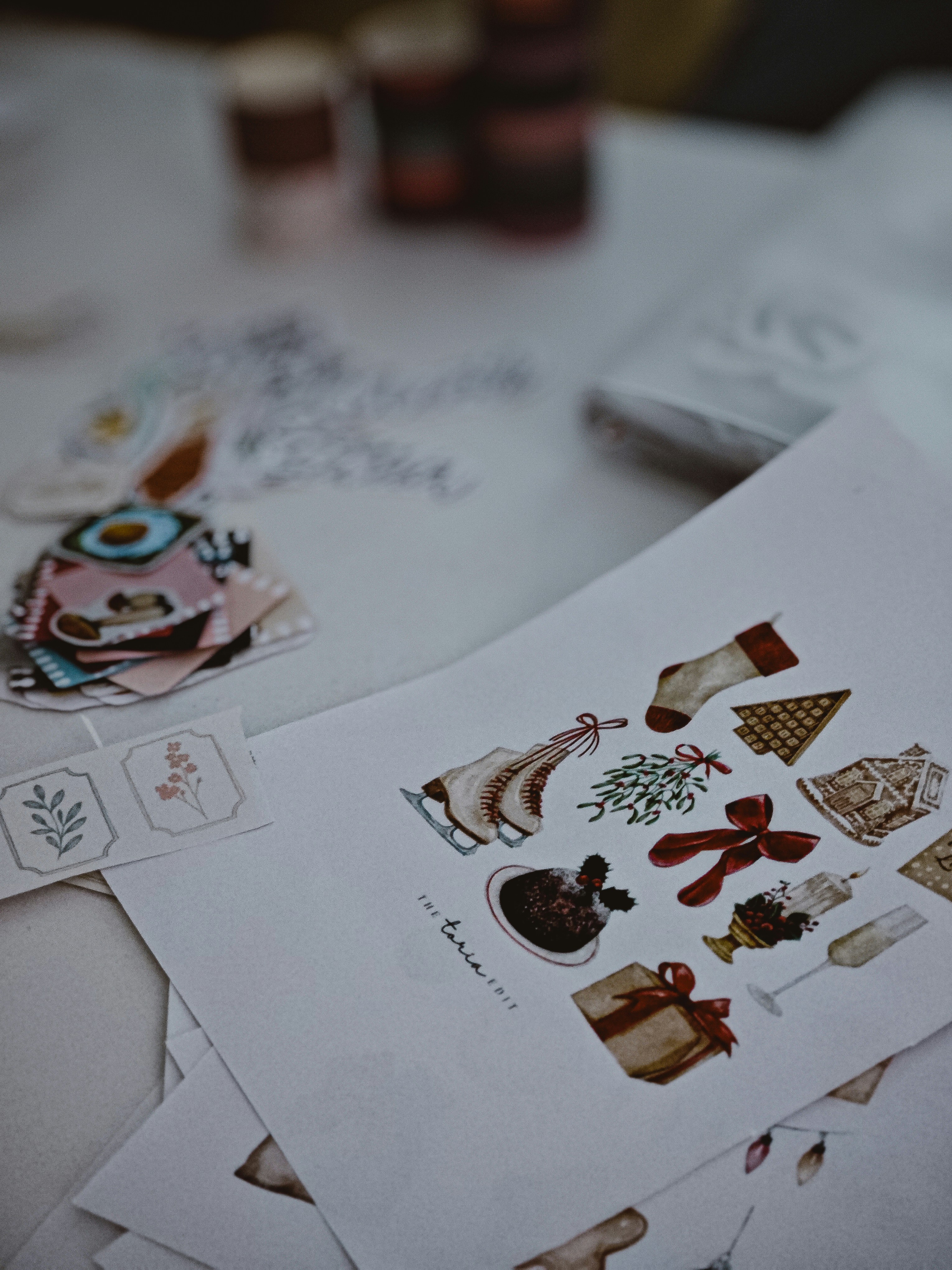 Christmas themed illustrations and stickers on a table.