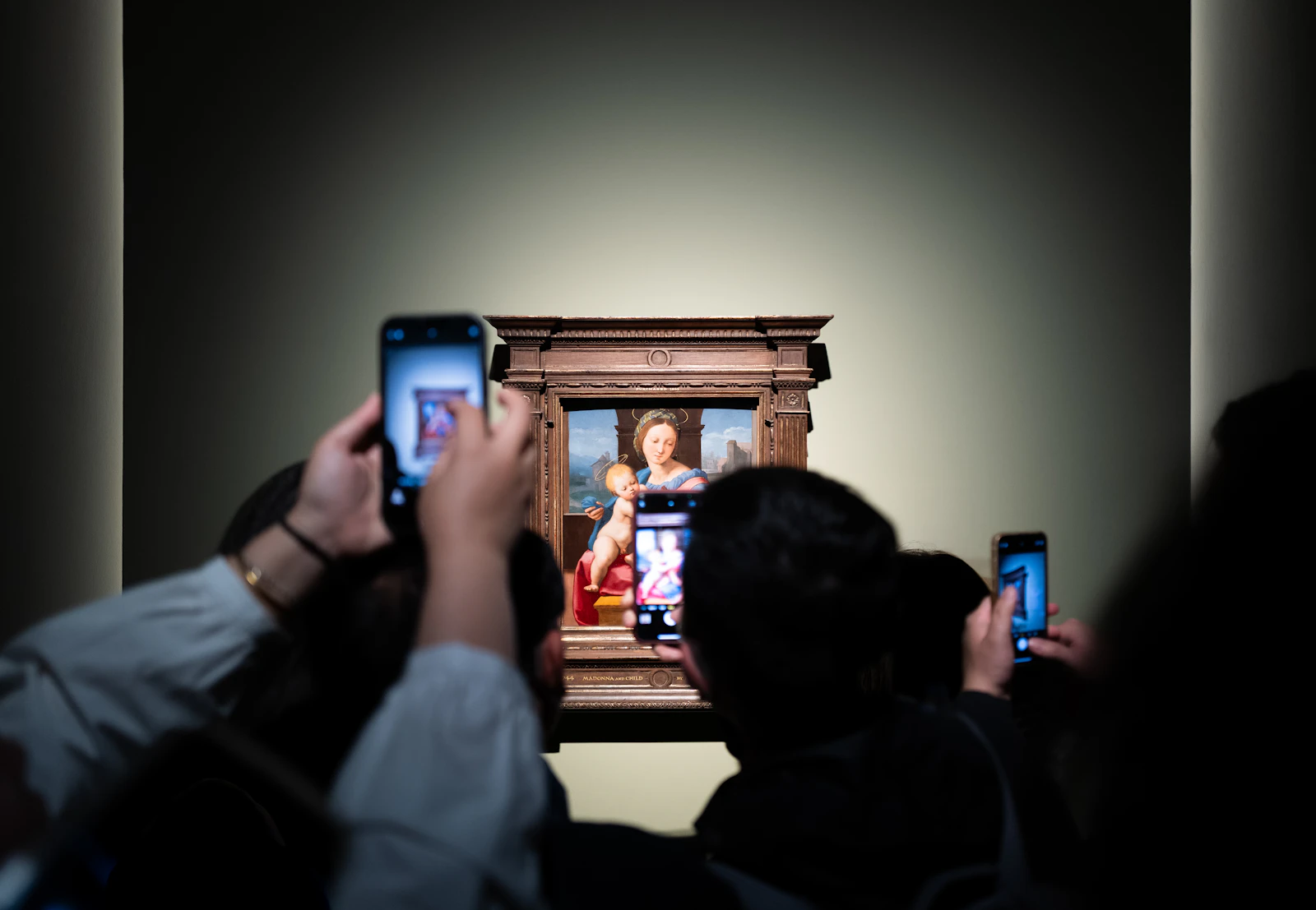 Visitors looking at art inside a museum gallery
