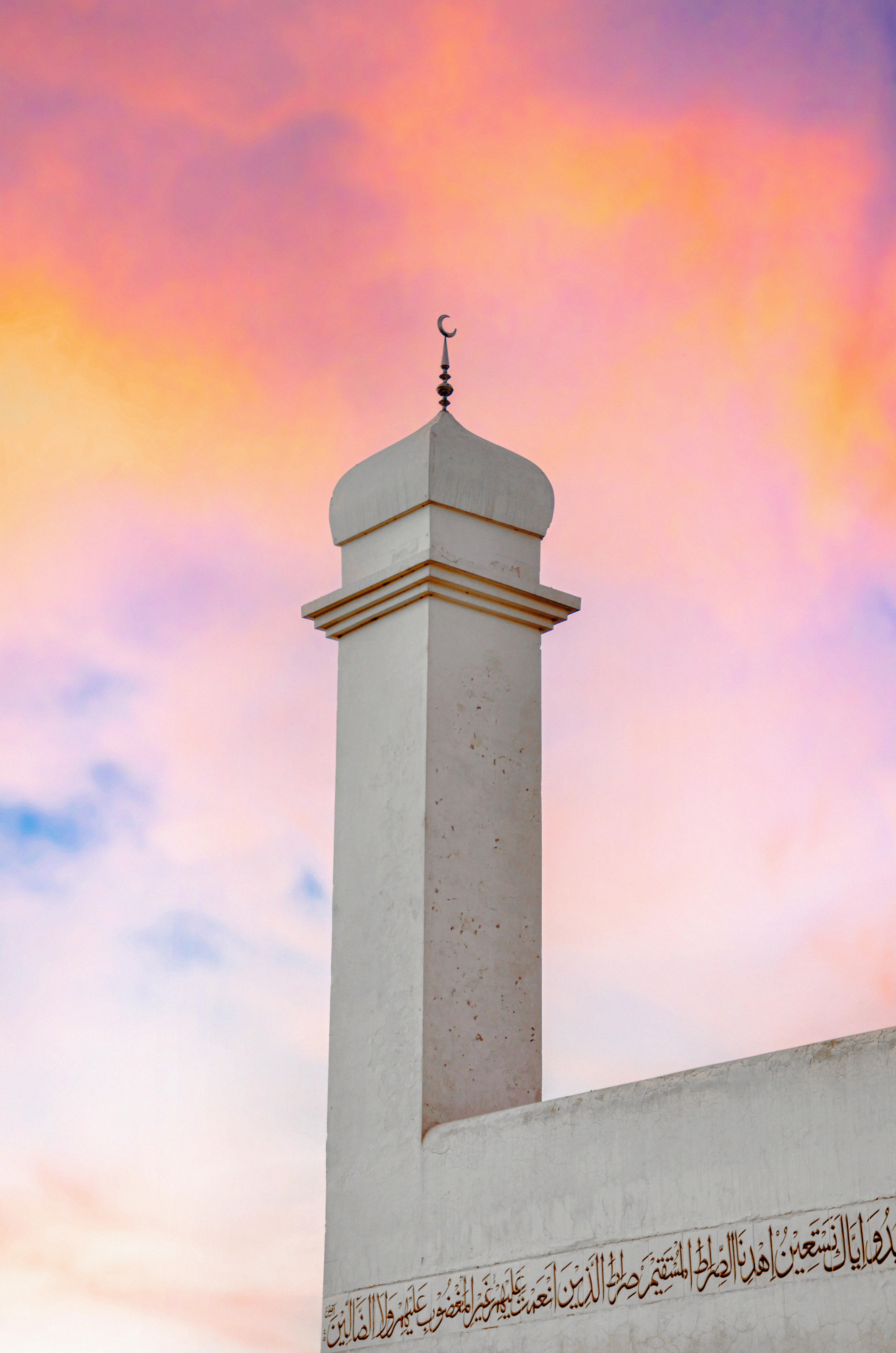 The masjid minaret silhouetted at sunset