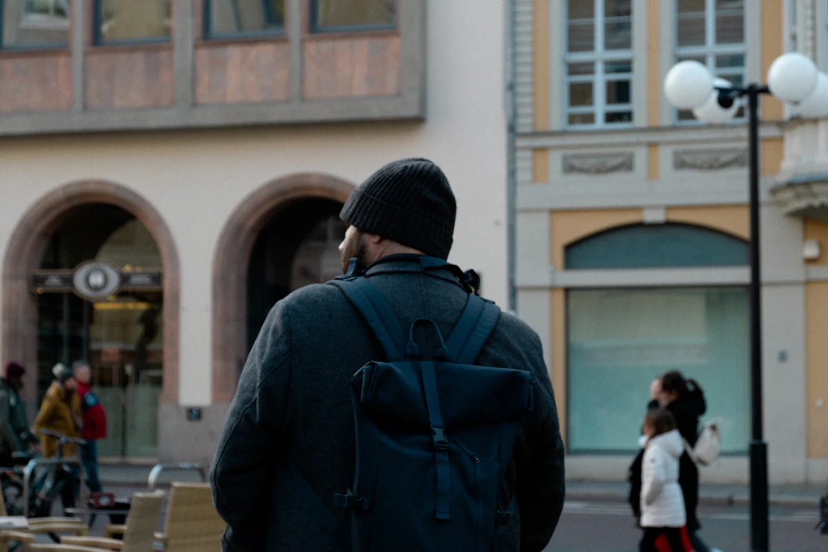 Person with a backpack walking through a city