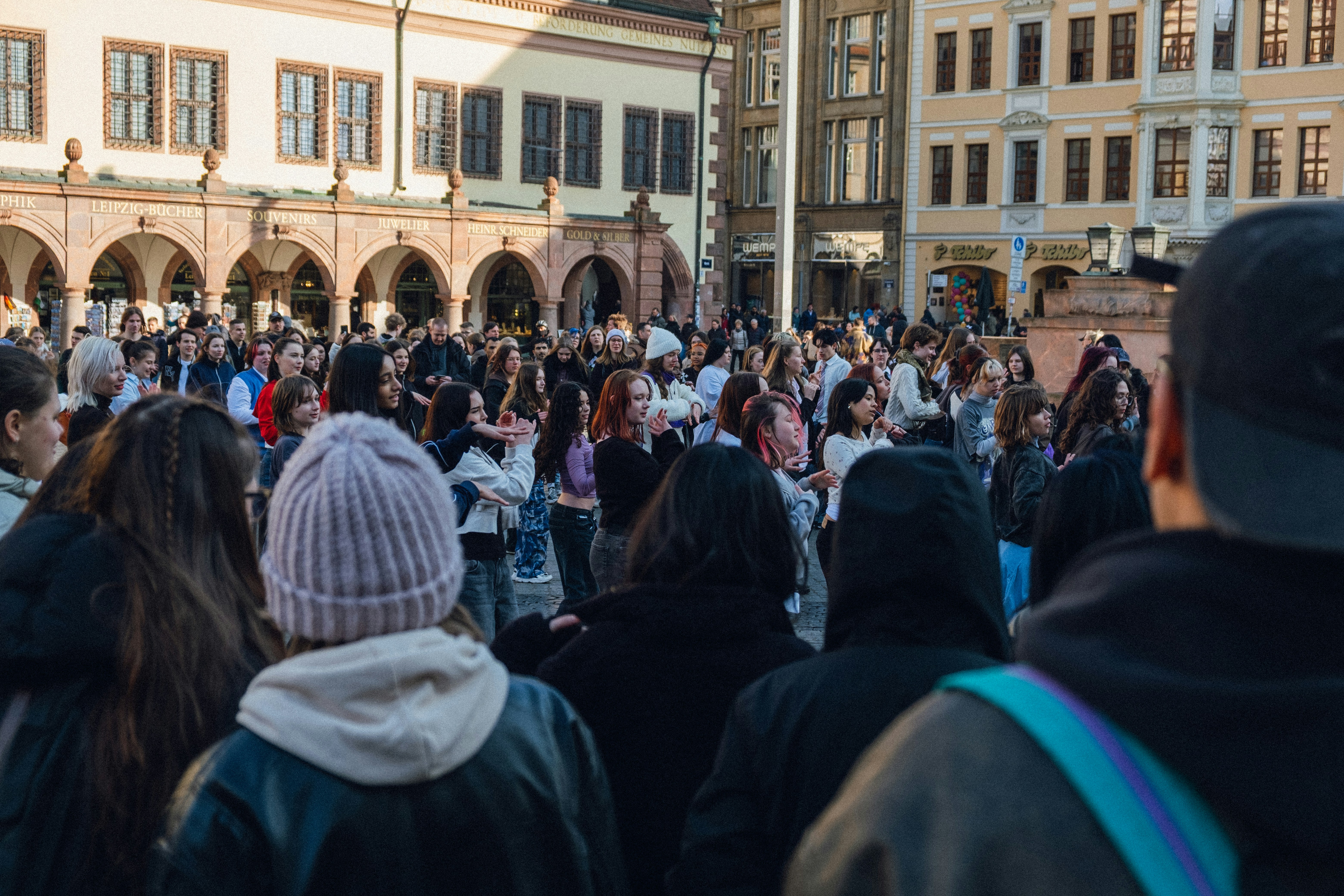 A large crowd of people gather outdoors. (Photo by Ben Kupke on Unsplash)