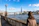 Woman looks toward the london skyline on a sunny day.