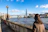 Woman looks toward the london skyline on a sunny day.