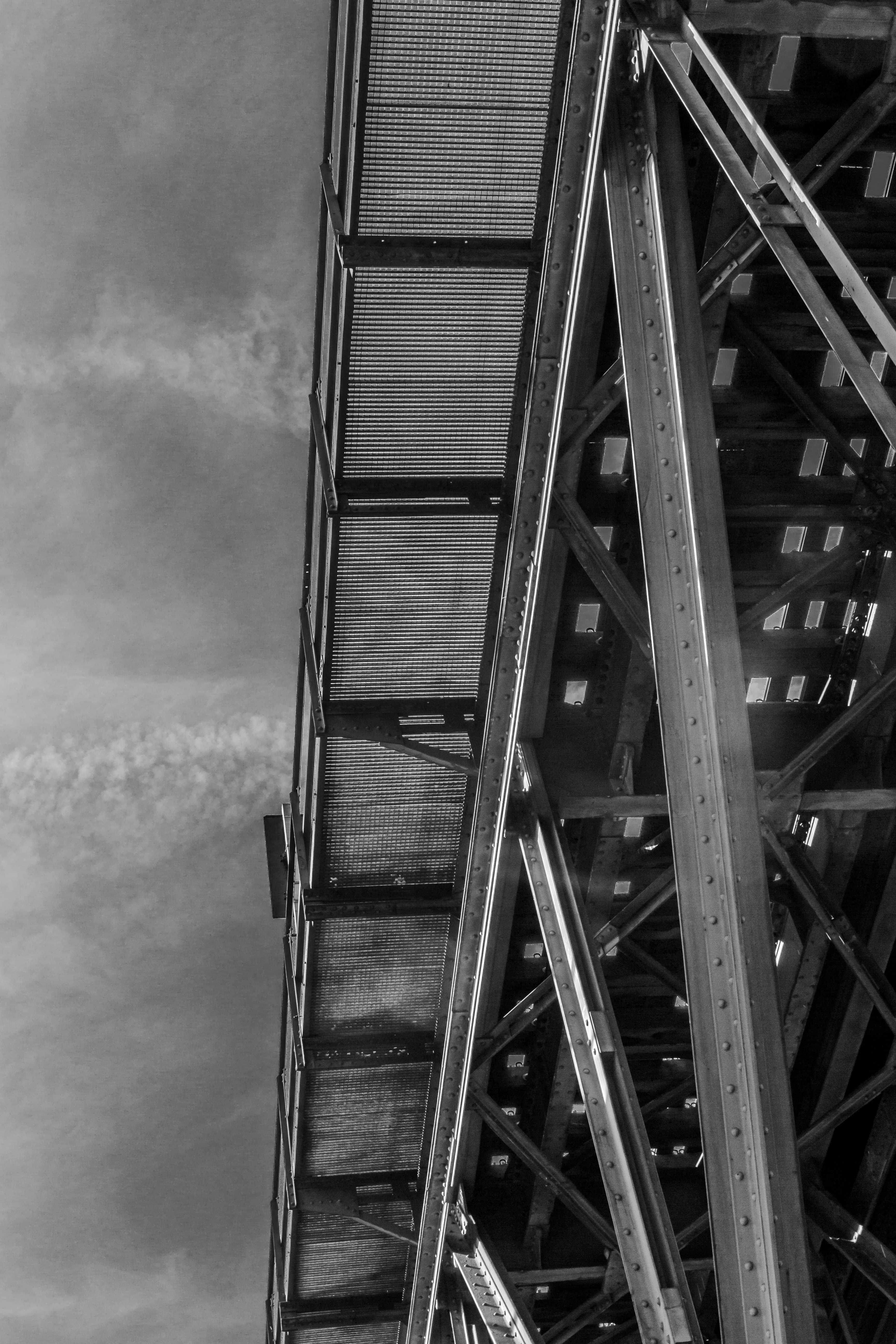 Below view of a bridge structure against the sky.