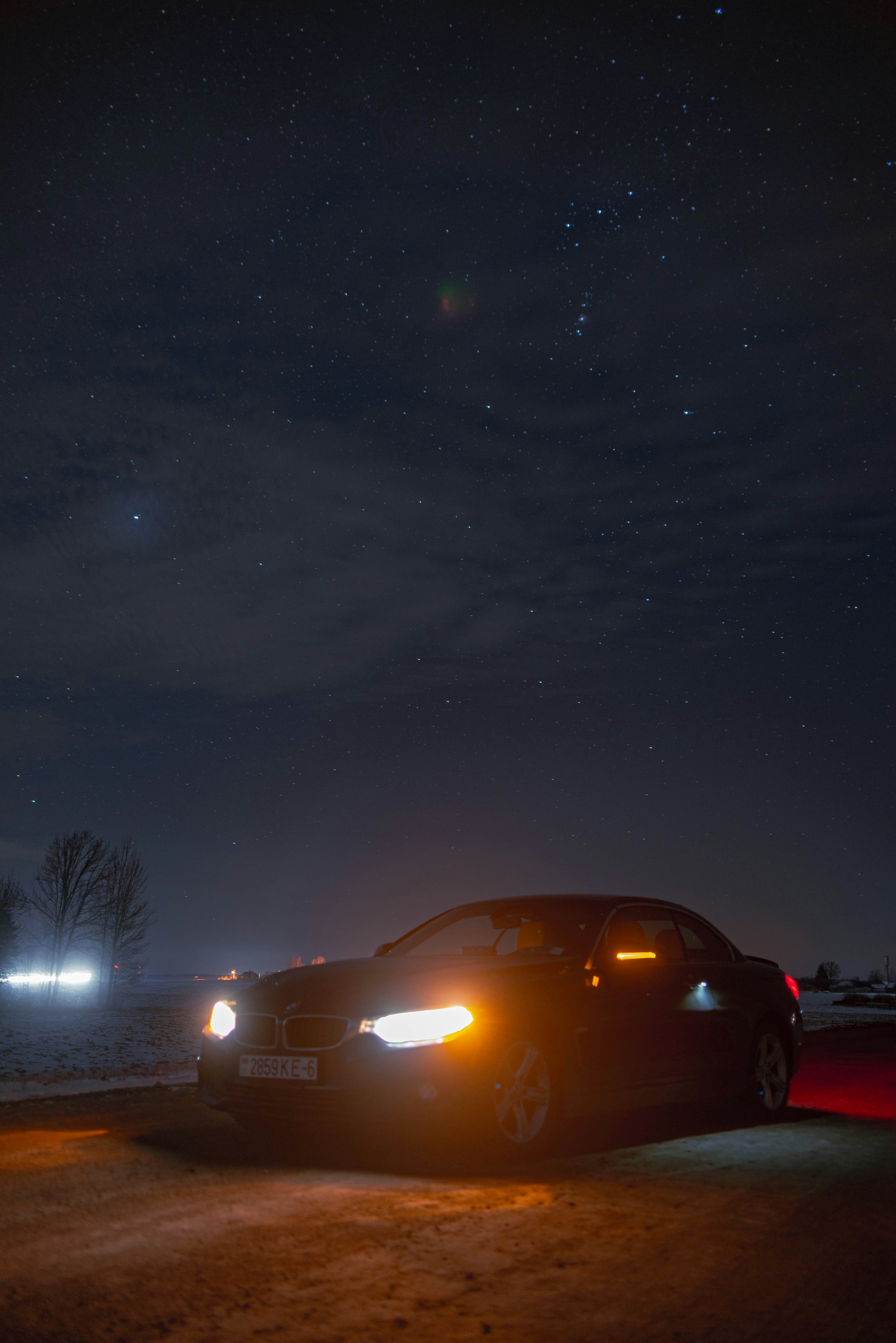 Car parked under a starry night sky.
