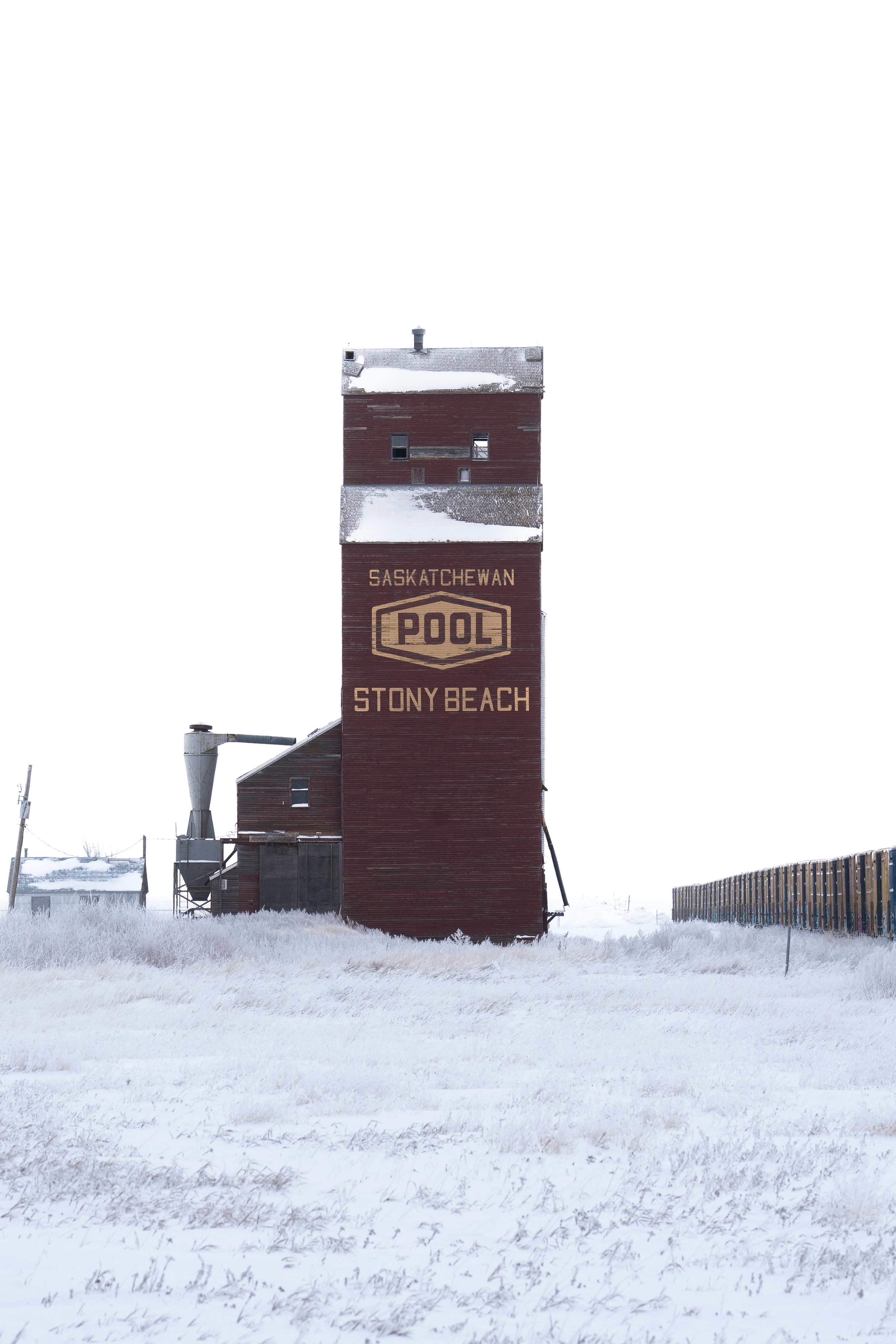 Snowy landscape with an old grain elevator.