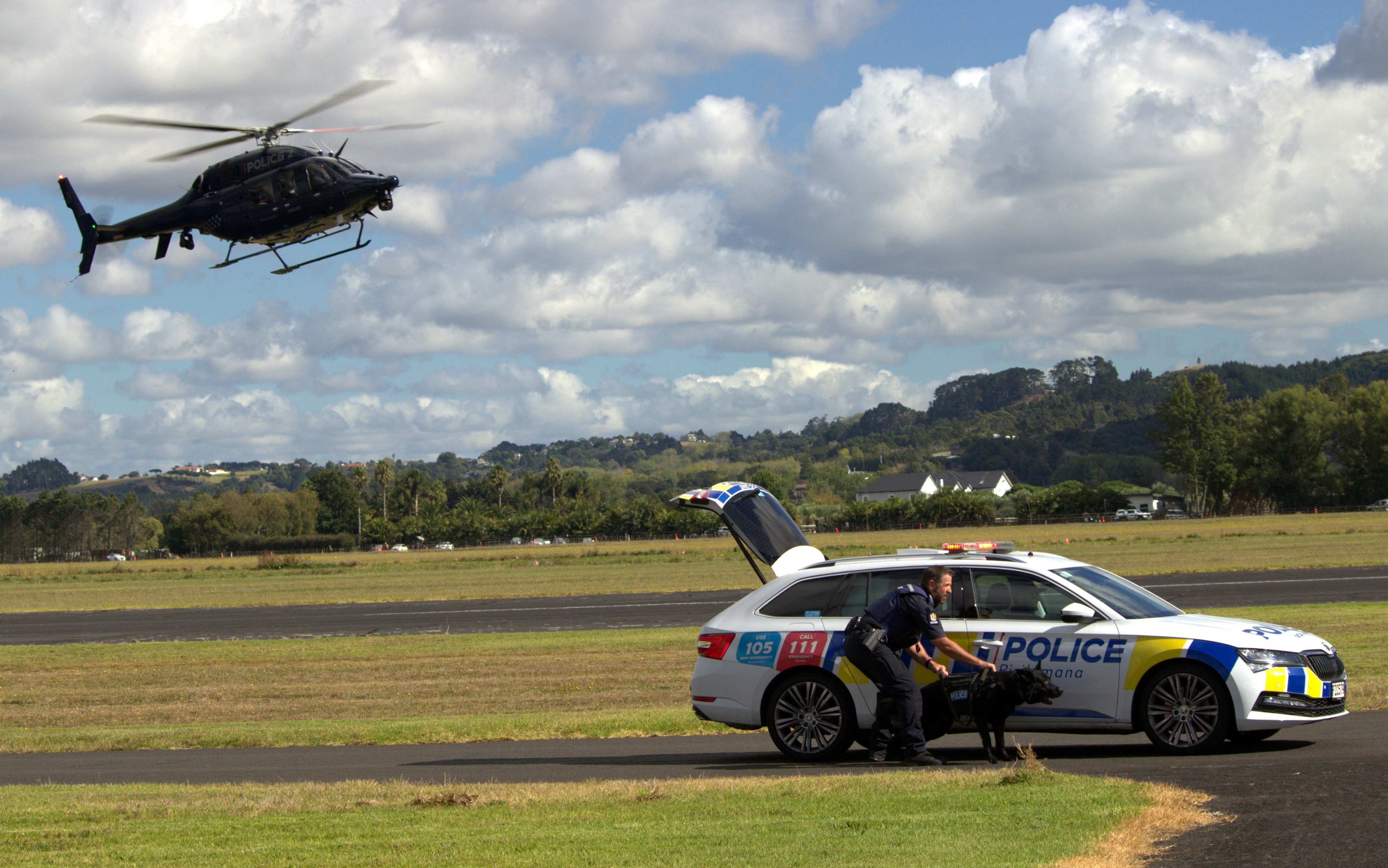Police and helicopter working at a crime scene.