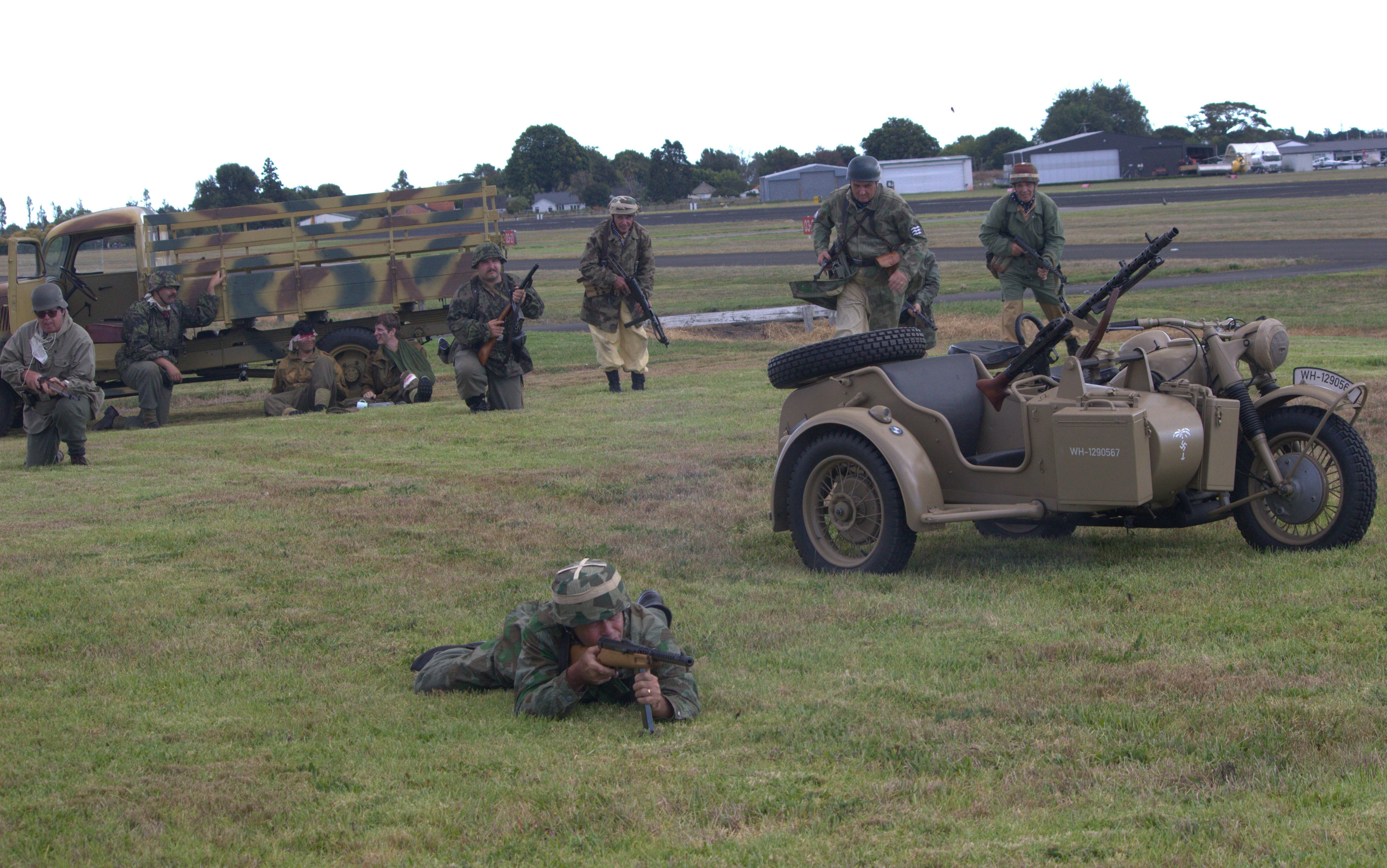 Soldiers and military vehicles are on the field