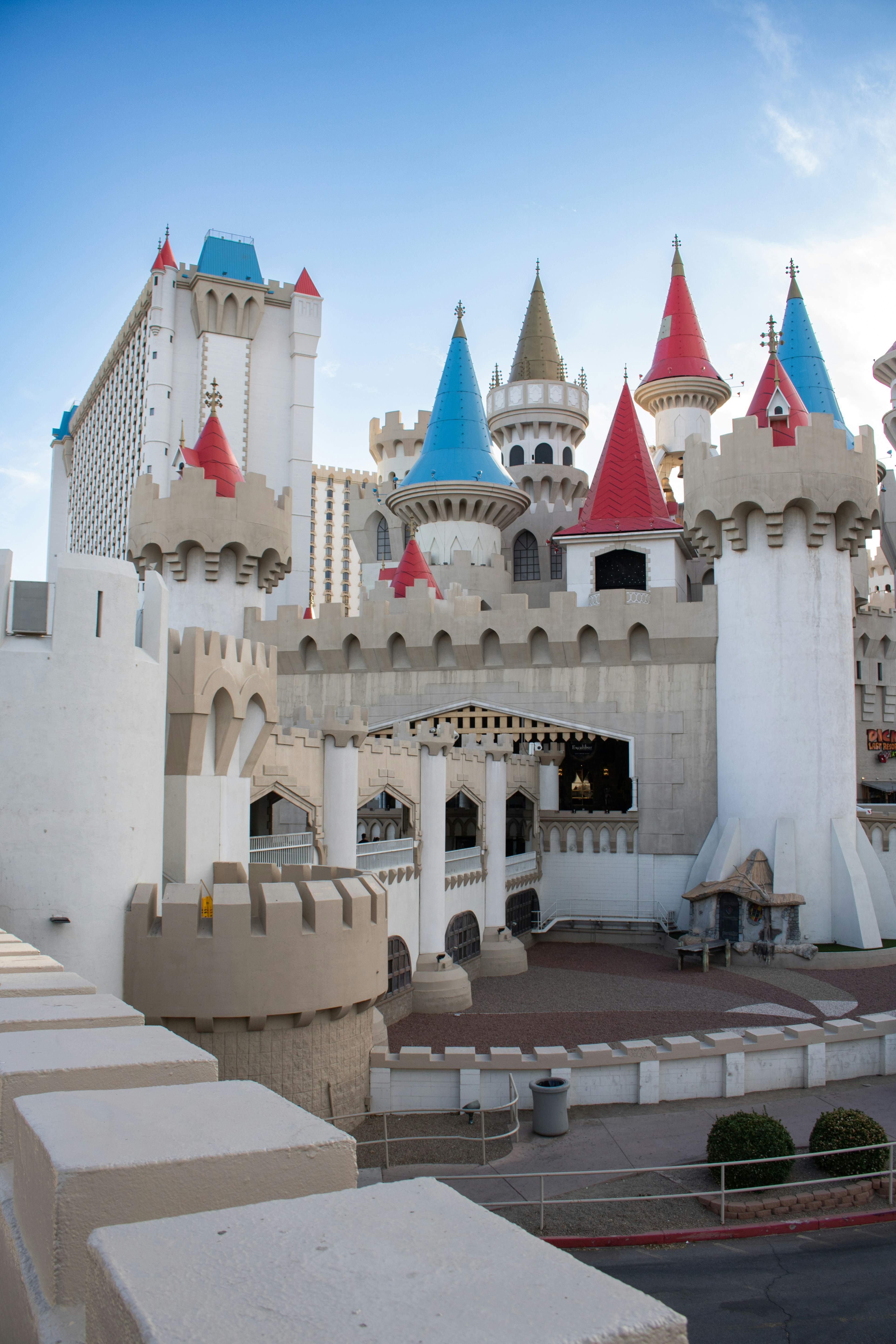 A castle-themed hotel stands tall under a blue sky.