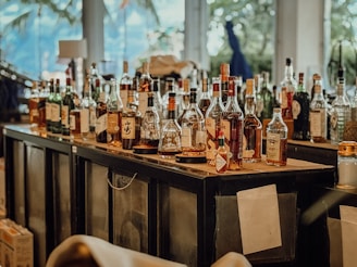 A bar is filled with different bottles of liquor.