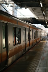 A train waits at a railway station platform.