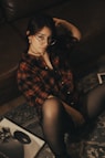 Woman in plaid shirt poses for a photo.