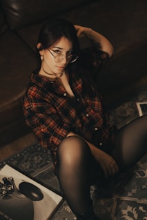 Woman in plaid shirt poses for a photo.