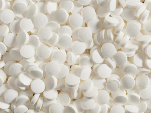 Piles of small, white tablets fill the space.