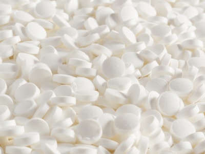 A pile of white tablets is shown.