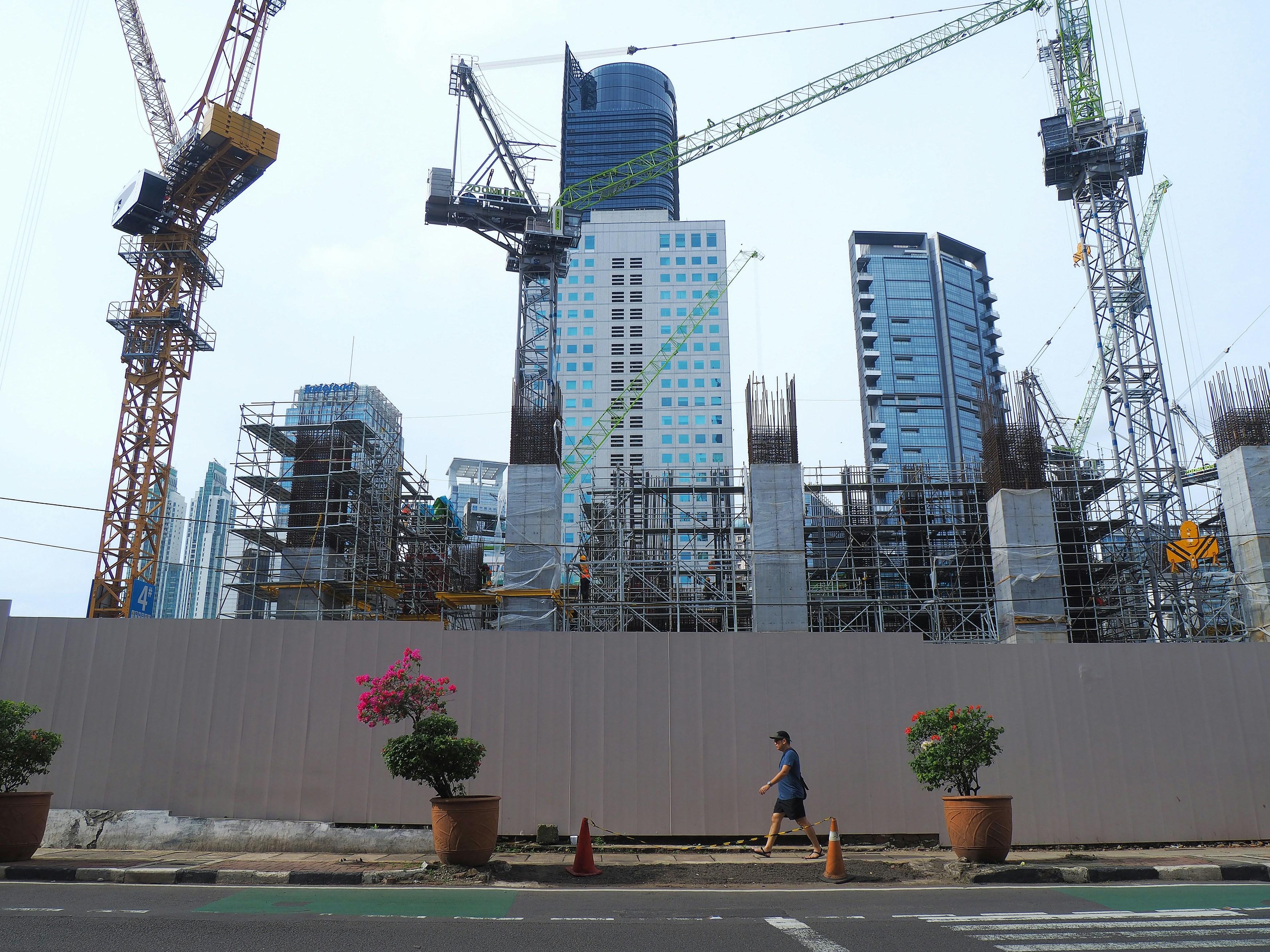 Construction site with cranes and buildings being built.