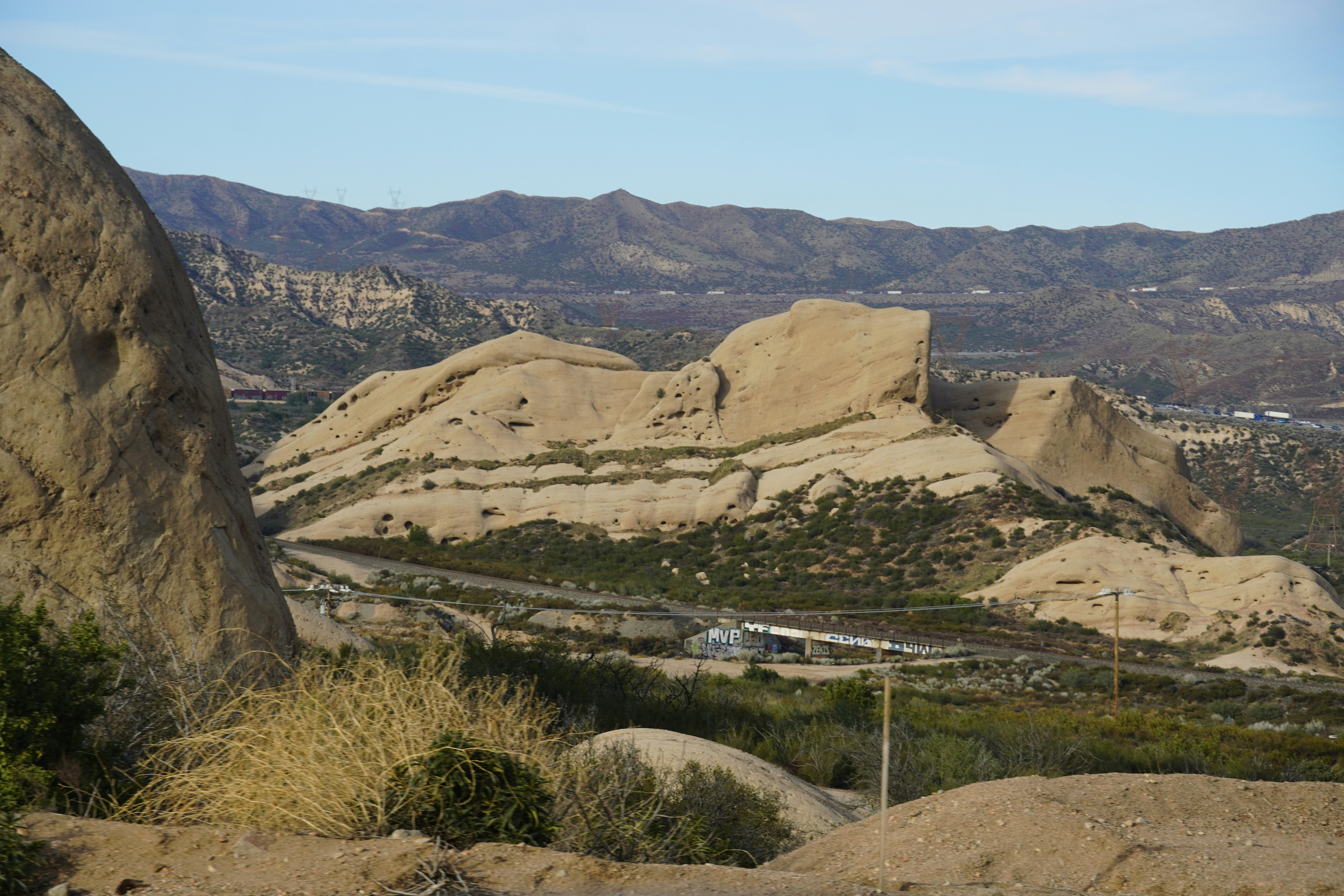 Rocky terrain with mountains in the background.
