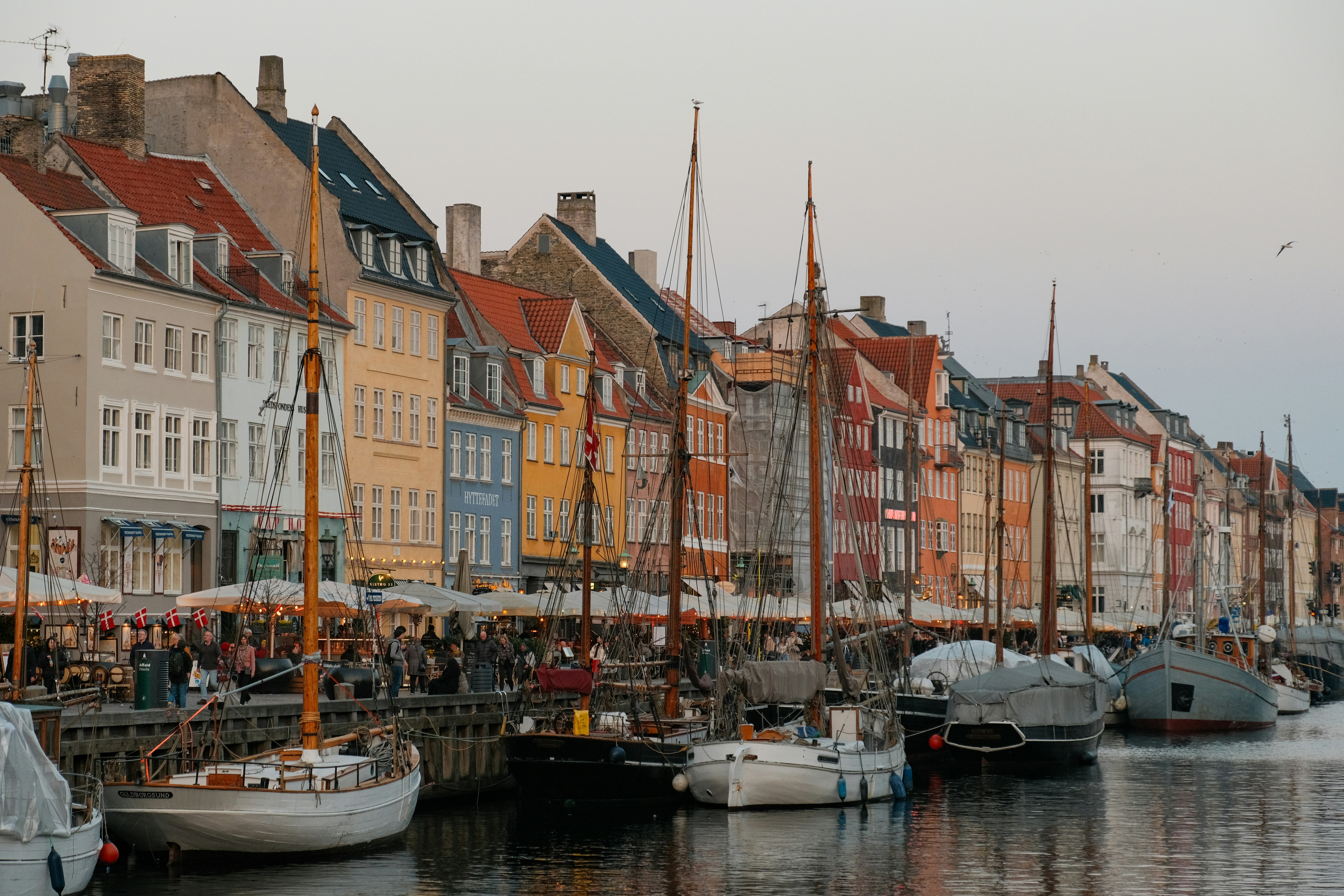 Colorful buildings and boats line a canal.
