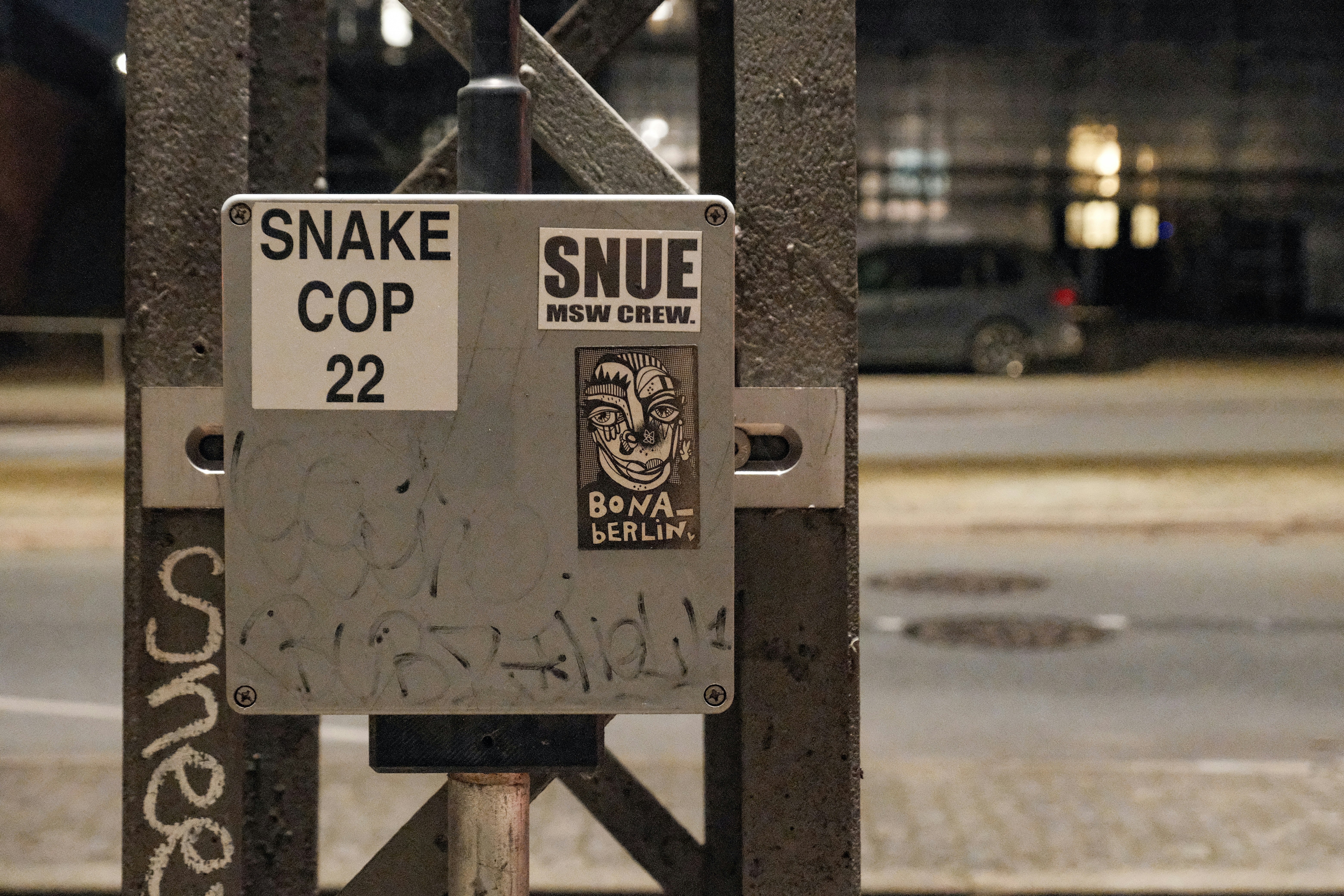 Street art stickers are shown on a utility box.