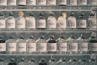 Many glass bottles lined up on shelves.