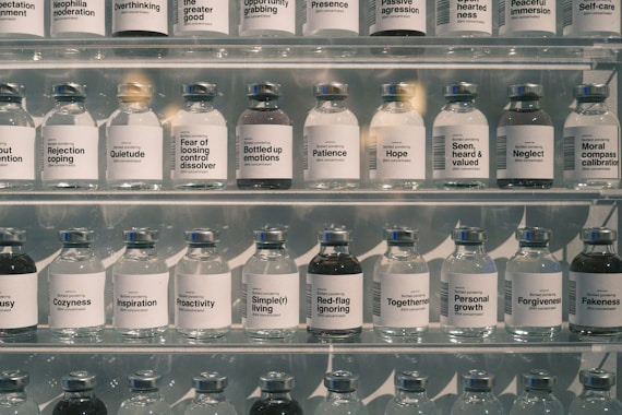 Many glass bottles lined up on shelves.