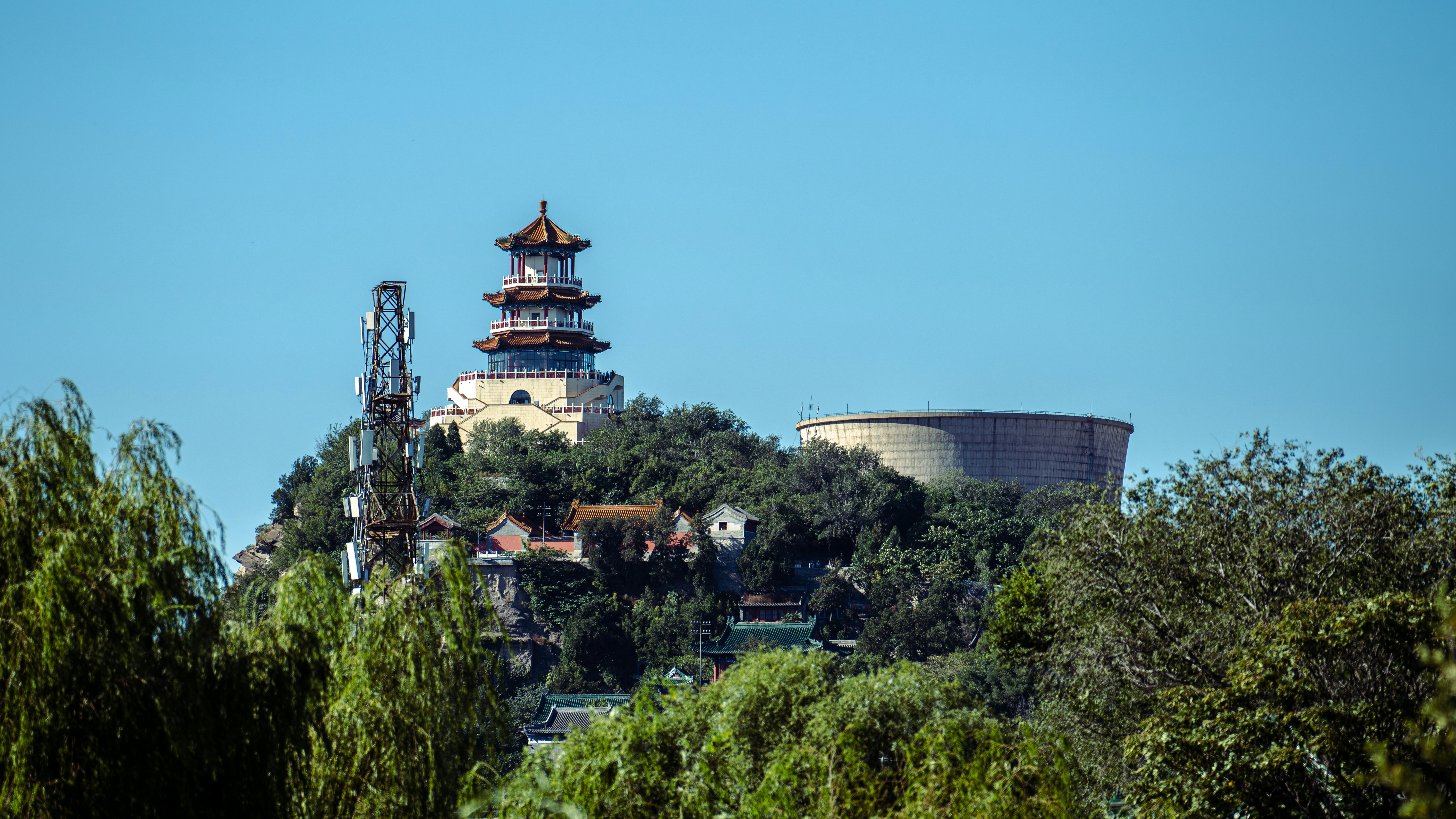 Ancient temple sits atop a green hill.